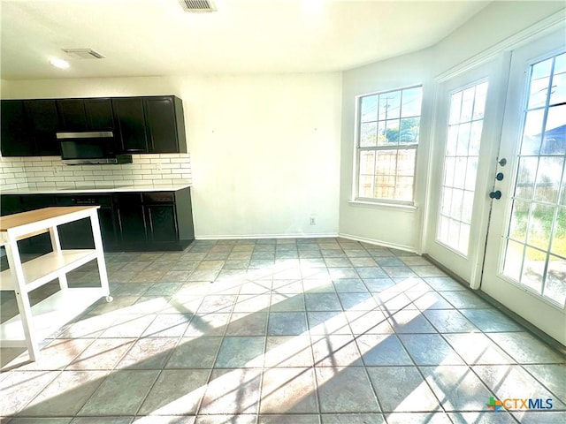 kitchen with french doors, light tile patterned flooring, and backsplash