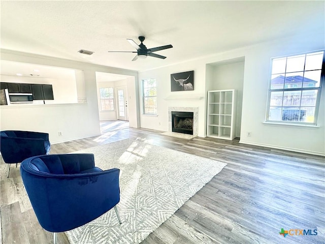 living room featuring ceiling fan and hardwood / wood-style flooring