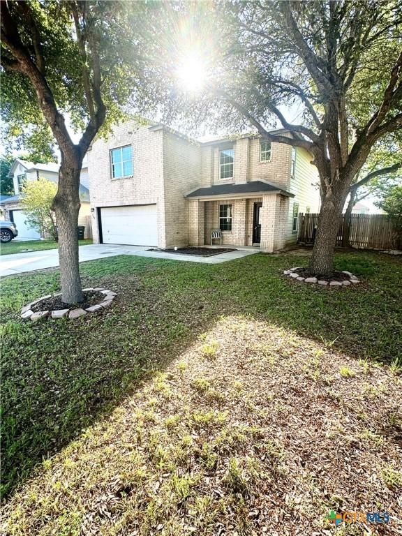 front facade featuring a front lawn and a garage