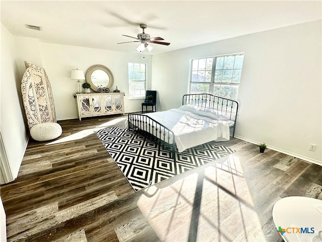 bedroom with ceiling fan and dark hardwood / wood-style floors