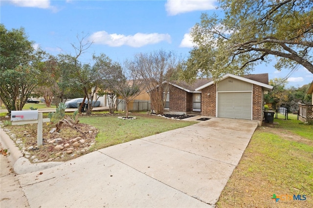 view of front of home featuring fence, concrete driveway, a front yard, a garage, and brick siding