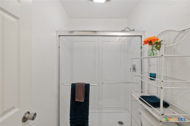 bathroom with a shower with shower door