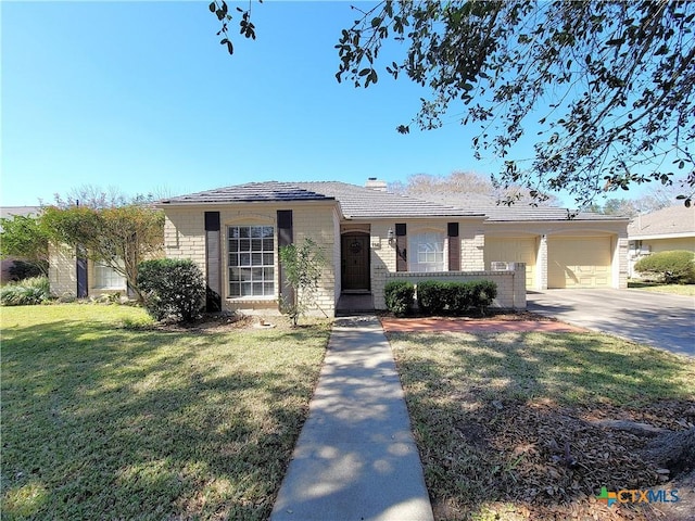 single story home featuring a garage, brick siding, driveway, and a front lawn