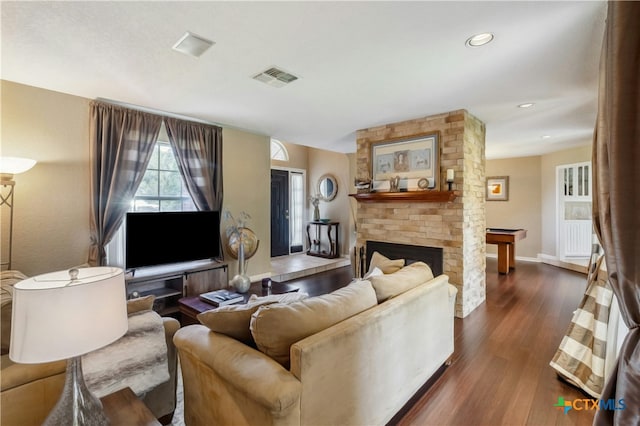 514 Duncan Dr, San Marcos, TX 78666 - living room with dark wood-style flooring, a large fireplace, baseboards, and recessed lighting