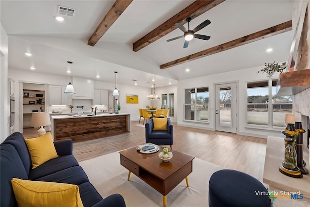 living room featuring recessed lighting, visible vents, vaulted ceiling with beams, and light wood-style flooring