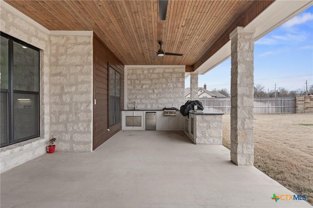 view of patio featuring fence, grilling area, a ceiling fan, and area for grilling