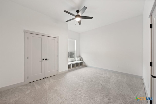 unfurnished bedroom with ceiling fan, carpet flooring, and baseboards