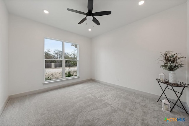 carpeted empty room featuring baseboards, a ceiling fan, and recessed lighting