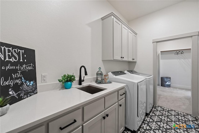 laundry area with carpet floors, washing machine and dryer, a sink, and cabinet space