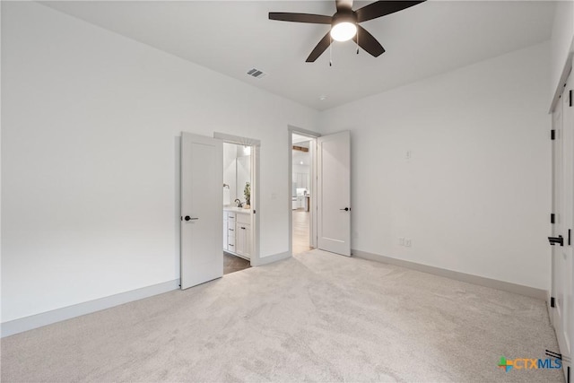 unfurnished bedroom featuring carpet flooring, visible vents, baseboards, and ensuite bathroom