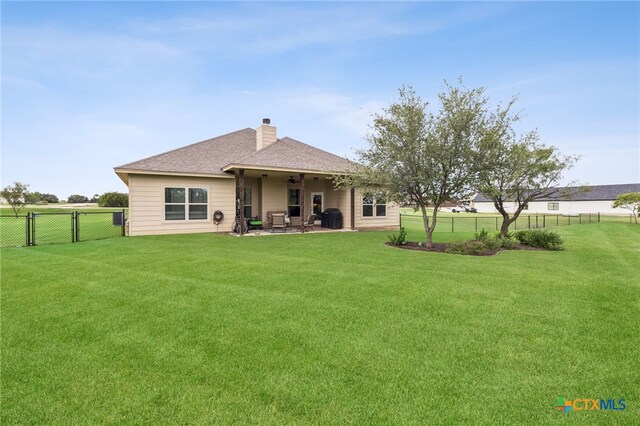 304 Campo Colinas Dr, Bertram, TX 78605 - rear view of house featuring ceiling fan, a fenced backyard, a patio, a chimney, and roof with shingles