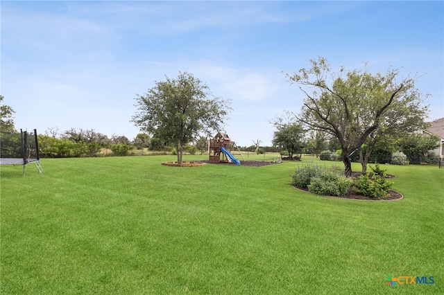 304 Campo Colinas Dr, Bertram, TX 78605 - view of grassy yard with a playground