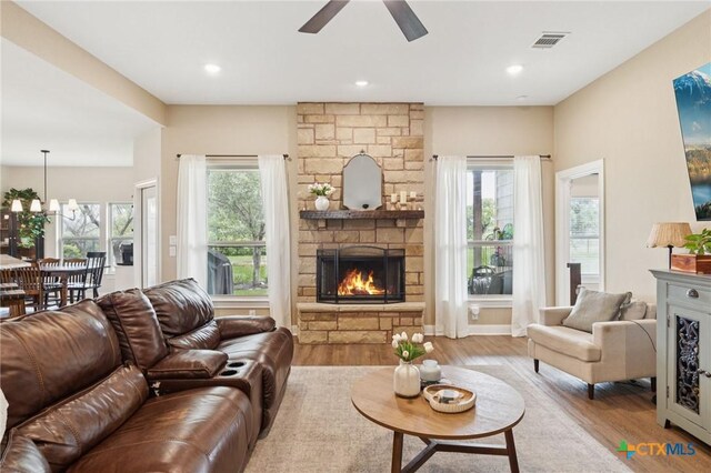 304 Campo Colinas Dr, Bertram, TX 78605 - living area with a stone fireplace, ceiling fan, wood finished floors, and recessed lighting