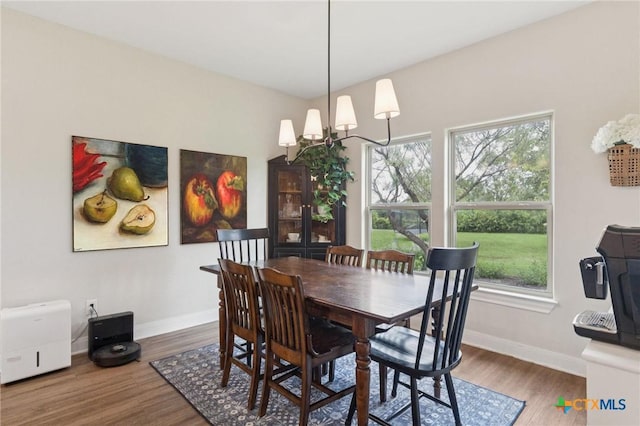 304 Campo Colinas Dr, Bertram, TX 78605 - dining area with plenty of natural light, wood finished floors, and a chandelier