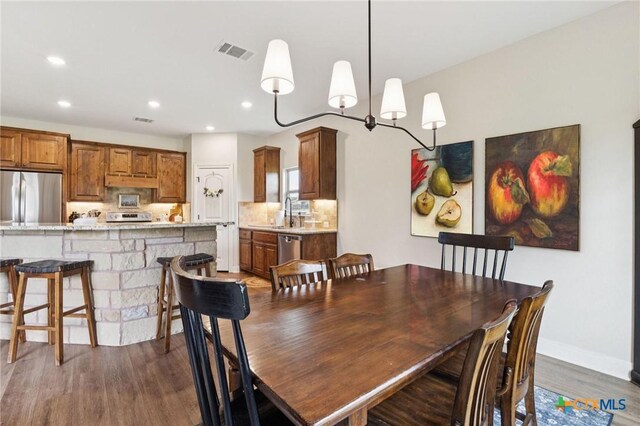 304 Campo Colinas Dr, Bertram, TX 78605 - dining room with dark wood finished floors and recessed lighting