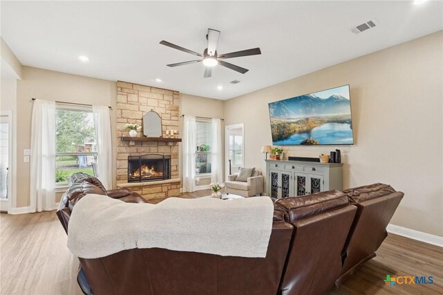 304 Campo Colinas Dr, Bertram, TX 78605 - living area with ceiling fan, wood finished floors, a fireplace, and recessed lighting