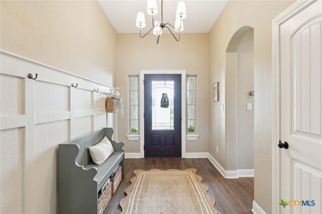 304 Campo Colinas Dr, Bertram, TX 78605 - entrance foyer with wood finished floors, arched walkways, and a chandelier