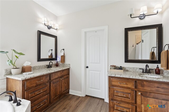304 Campo Colinas Dr, Bertram, TX 78605 - bathroom featuring wood finished floors, vanity, and a bathtub