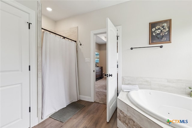 304 Campo Colinas Dr, Bertram, TX 78605 - full bath with wood finished floors, a whirlpool tub, and curtained shower