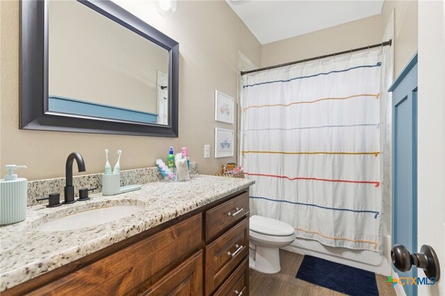 304 Campo Colinas Dr, Bertram, TX 78605 - bathroom with vanity, wood finished floors, and shower / bath combo