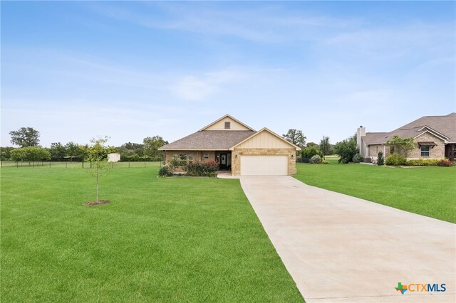 304 Campo Colinas Dr, Bertram, TX 78605 - view of front of home featuring driveway, an attached garage, and brick siding