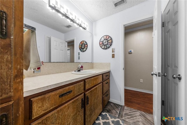 bathroom featuring vanity and a textured ceiling