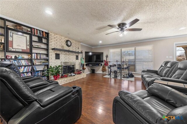 living room featuring crown molding, ceiling fan, dark hardwood / wood-style floors, and a textured ceiling