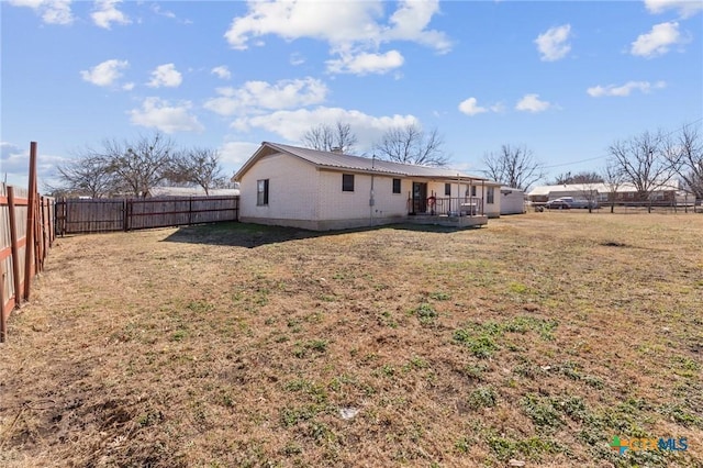 back of house with a yard