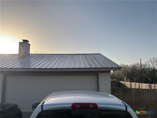 garage at dusk with fence