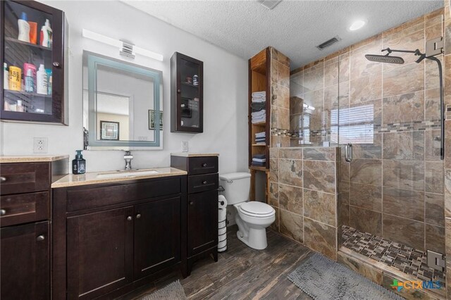 entrance foyer with ornamental molding, a textured ceiling, and dark hardwood / wood-style flooring