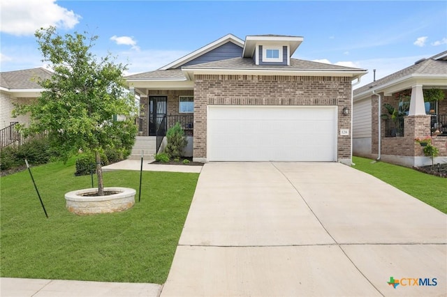 128 Riverhill Dr, Georgetown, TX 78628 - view of front of house featuring brick siding, a front lawn, driveway, an attached garage, and roof with shingles