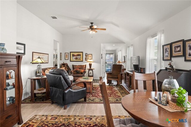 128 Riverhill Dr, Georgetown, TX 78628 - living area with a ceiling fan, light wood finished floors, and vaulted ceiling