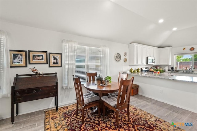 128 Riverhill Dr, Georgetown, TX 78628 - dining space with wood tiled floors, lofted ceiling, baseboards, and recessed lighting