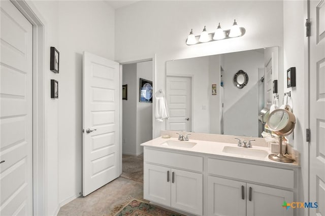 128 Riverhill Dr, Georgetown, TX 78628 - bathroom featuring double vanity and baseboards