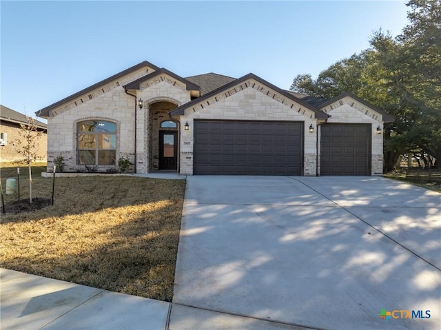 view of front facade with a garage and a front lawn