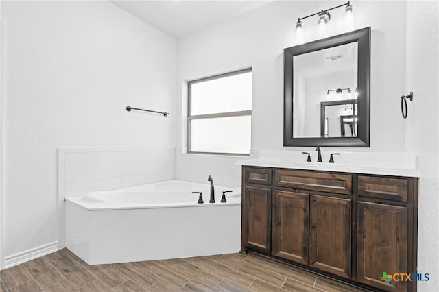 bathroom with vanity and a bathtub