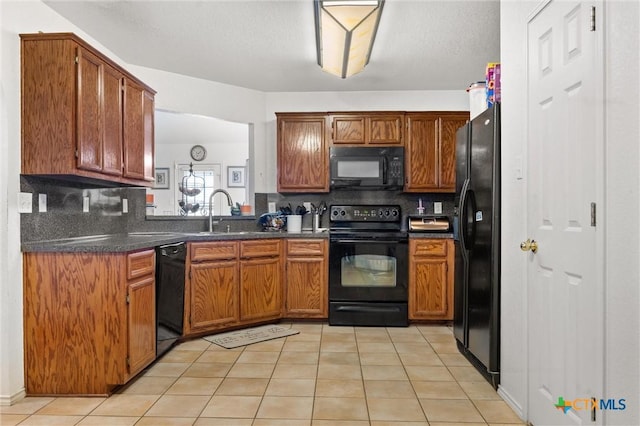 2416 Griffin Dr, Copperas Cove, TX 76522 - kitchen featuring black appliances, a sink, dark countertops, and decorative backsplash