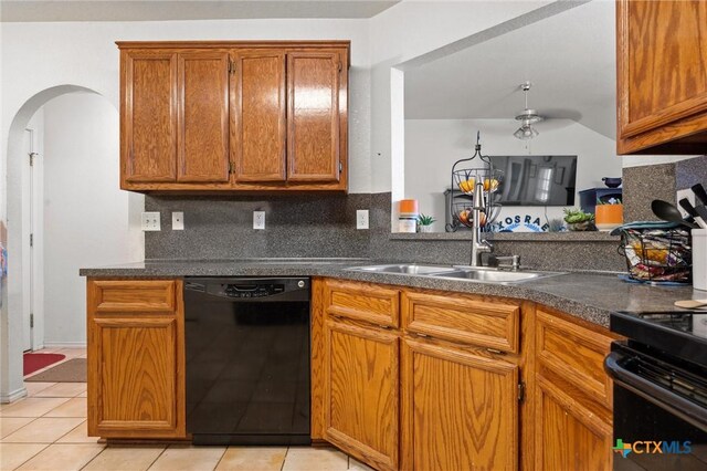 2416 Griffin Dr, Copperas Cove, TX 76522 - kitchen featuring black appliances, arched walkways, a sink, brown cabinetry, and dark countertops