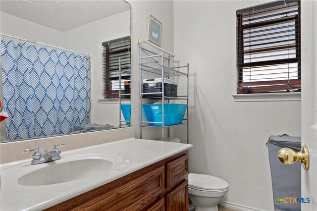 2416 Griffin Dr, Copperas Cove, TX 76522 - bathroom featuring toilet, vanity, and a shower with shower curtain