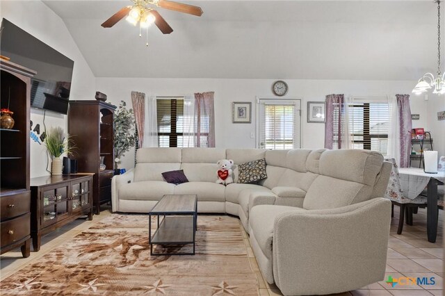 2416 Griffin Dr, Copperas Cove, TX 76522 - tiled living room with lofted ceiling, a ceiling fan, and a chandelier