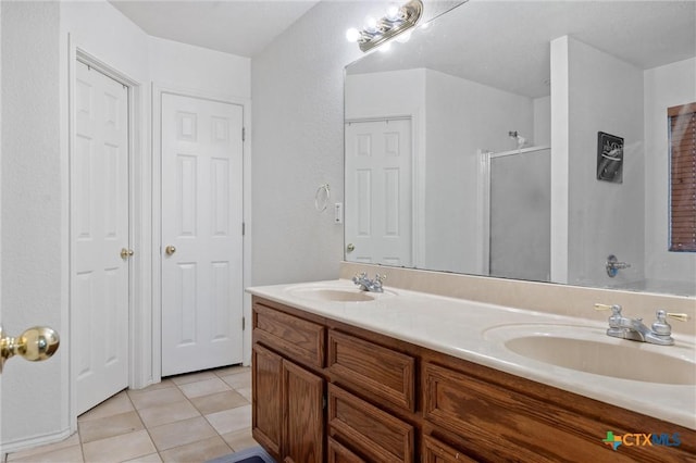 2416 Griffin Dr, Copperas Cove, TX 76522 - bathroom featuring a stall shower, tile patterned floors, and double vanity