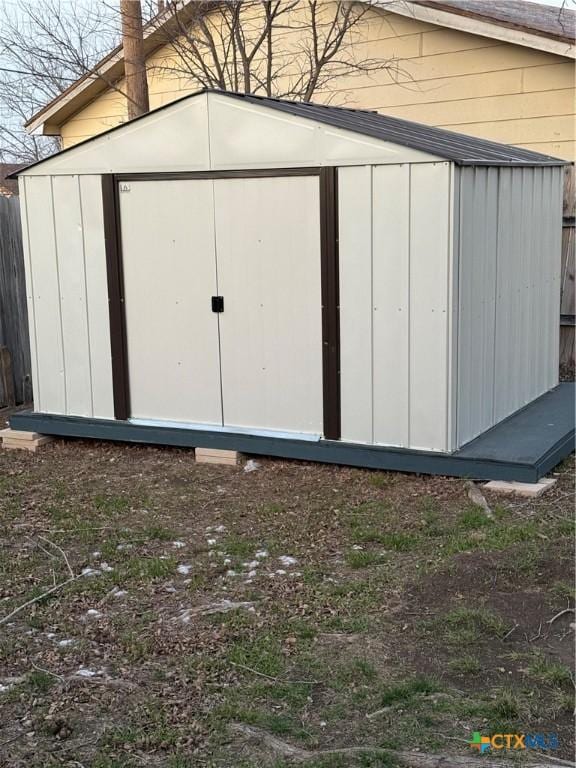 view of shed with fence