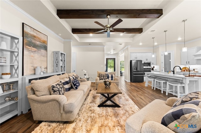 living room with ceiling fan, beamed ceiling, dark hardwood / wood-style flooring, and ornamental molding