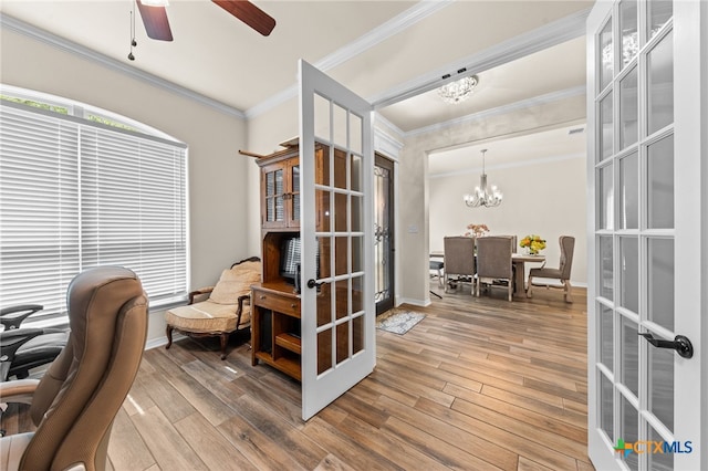 living area featuring hardwood / wood-style flooring, french doors, and ornamental molding