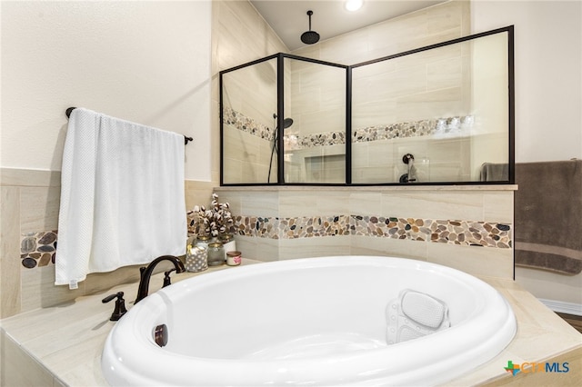 bathroom featuring a relaxing tiled tub