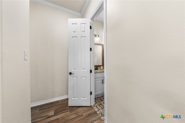 corridor featuring dark hardwood / wood-style flooring and crown molding