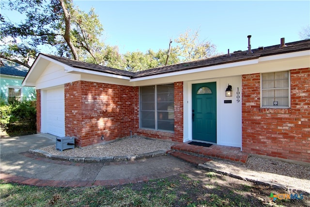 view of exterior entry with a garage