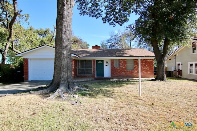 ranch-style home featuring a garage and a front lawn