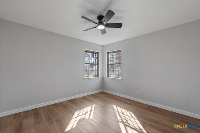 spare room featuring hardwood / wood-style flooring and ceiling fan