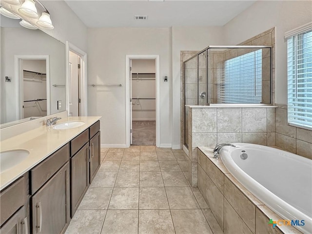 2241 Windswept Wy Way, New Braunfels, TX 78132 - full bathroom featuring a shower stall, a bath, a walk in closet, double vanity, and tile patterned flooring